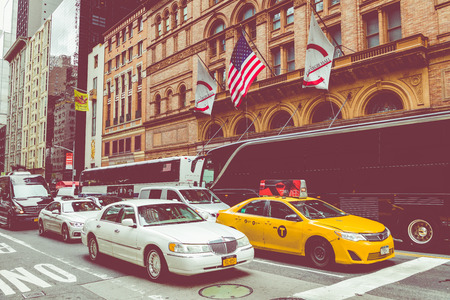 NEW YORK - SEPTEMBER 2, 2018: Yellow cab speeds through Times Square the busy tourist intersection of neon art and commerce and is an iconic street of New York City, USAのeditorial素材