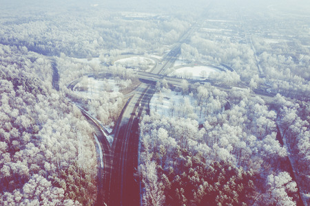 Rime and hoarfrost covering trees. Aerial view of the snow-covered forest and lake from above....