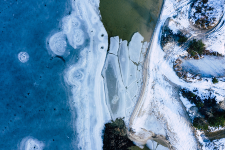 Aerial view of frozen lake. Winter scenery. Landscape photo captured with drone above winter wonderland.の写真素材