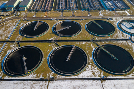 Sewage farm. Static aerial photo looking down onto the clarifying tanks. Industrial place. Geometric background texture. Photo captured with drone.の写真素材