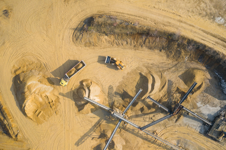 Aerial view of sandpit and factory plant producing sand materials for construction industry. Top view of industrial place. Photo captured with drone.の写真素材