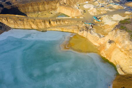 Aerial view of opencast mining quarry with lots of machinery. Industrial place view from above. Photo captured with drone.の写真素材