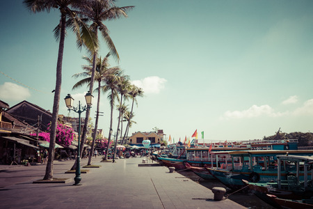 Traditional boats in front of ancient architecture in Hoi An, Vietnam. Hoi An is the World's Cultural heritage site, famous for mixed cultures & architecture.のeditorial素材