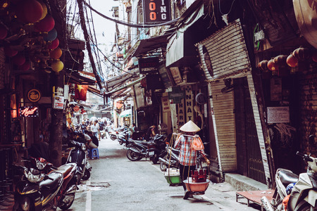 HANOI, VIETNAM - NOVEMBER 16, 2018 : The street vendors in Hanoi, Vietnam. Early morning on a busy street in city center.のeditorial素材