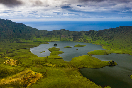 Aerial view of volcanic crater (Caldeirao) with a beautiful lake on the top of Corvo island. Azores islands, Portugal.の写真素材