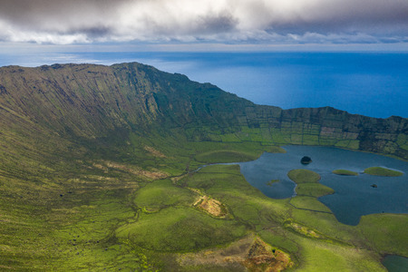 Aerial view of volcanic crater (Caldeirao) with a beautiful lake on the top of Corvo island. Azores islands, Portugal.の写真素材