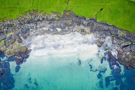 Aerial view of Koltur island in Faroe Islands, North Atlantic Ocean. Photo made by drone from above. Nordic Natural Landscape.の写真素材