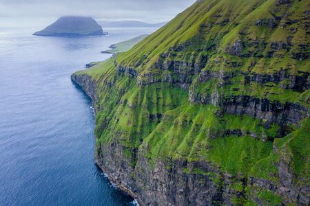 Aerial view of Koltur island in Faroe Islands, North Atlantic Ocean. Photo made by drone from above. Nordic Natural Landscape.の写真素材