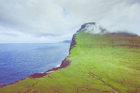 Aerial view of Koltur island in Faroe Islands, North Atlantic Ocean. Photo made by drone from above. Nordic Natural Landscape.の写真素材