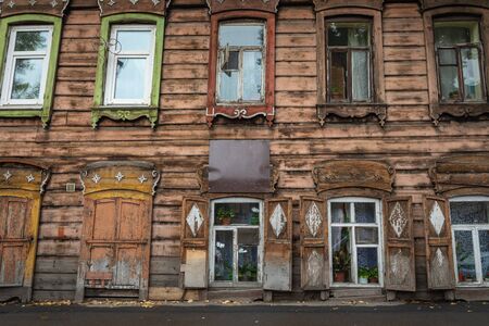 Window with the wooden carved architrave in the old wooden house in the old Russian town. Irkutskの写真素材