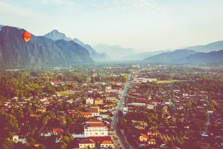 Hot air balloon over Nam Song river at sunrise in Vang vieng, Laos. Asia.の写真素材