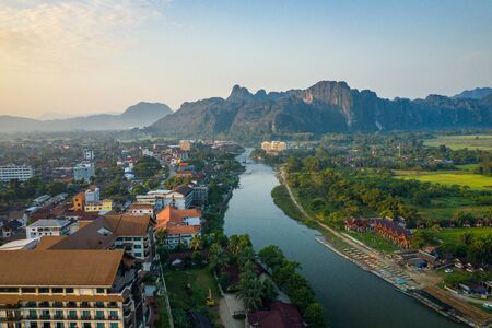 Aerial view of village Vang Vieng and  Nam Song river , Laos. Southeast Asia. Photo made by drone from above. Bird eye view.の写真素材
