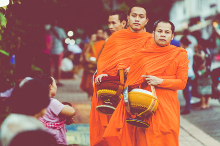 LUANG PRABANG, LAOS - OCTOBER 12, 2019: Buddhist monks on everyday morning traditional alms giving in Luang Prabang, Laos. のeditorial素材