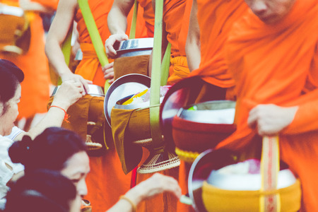 LUANG PRABANG, LAOS - OCTOBER 12, 2019: Buddhist monks on everyday morning traditional alms giving in Luang Prabang, Laos. のeditorial素材