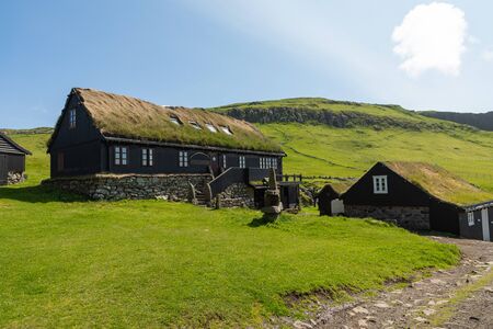 Beautiful village of Mykines with colorful houses with grass on the roofs, Mykines island, Faroe Islands, Europe.の写真素材
