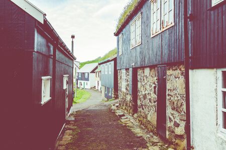 Beautiful village of Mykines with colorful houses with grass on the roofs, Mykines island, Faroe...