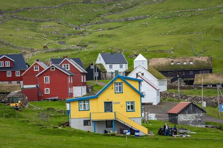 Beautiful village of Mykines with colorful houses with grass on the roofs, Mykines island, Faroe Islands, Europe.の写真素材