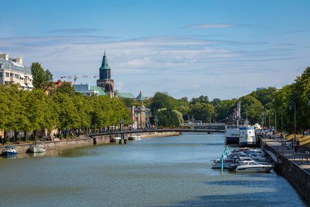 TURKU, FINLAND - AUGUST 02, 2019: View to the Aura river in Turku, Finland. Waterfront and harbour with ships and boats where are bars and restaurants. Turku is one of popular tourist destinations.のeditorial素材
