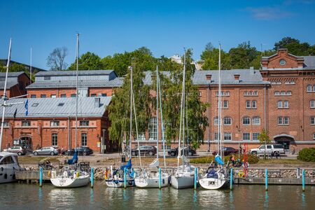 TURKU, FINLAND - AUGUST 02, 2019: View to the Aura river in Turku, Finland. Waterfront and harbour with ships and boats where are bars and restaurants. Turku is one of popular tourist destinations.のeditorial素材