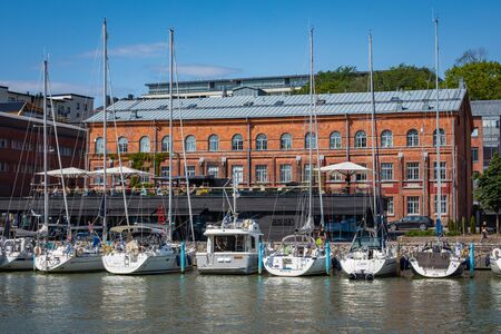 TURKU, FINLAND - AUGUST 02, 2019: View to the Aura river in Turku, Finland. Waterfront and harbour with ships and boats where are bars and restaurants. Turku is one of popular tourist destinations.のeditorial素材