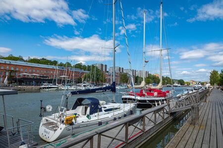 TURKU, FINLAND - AUGUST 02, 2019: View to the Aura river in Turku, Finland. Waterfront and harbour with ships and boats where are bars and restaurants. Turku is one of popular tourist destinations.のeditorial素材