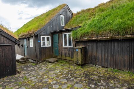 TORSHAVN, FAROE ISLANDS - JULY 05, 2019: Old town of capital city of Torshavn. Typical houses with peat roof ( grass roof ). Faroes Islands. Denmark. Europe.のeditorial素材