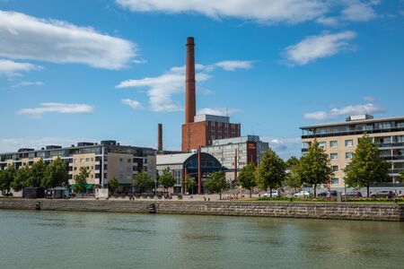 TURKU, FINLAND - AUGUST 02, 2019: View to the Aura river in Turku, Finland. Waterfront and harbour with ships and boats where are bars and restaurants. Turku is one of popular tourist destinations.のeditorial素材