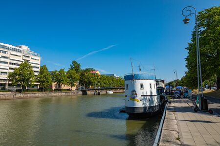 TURKU, FINLAND - AUGUST 02, 2019: View to the Aura river in Turku, Finland. Waterfront and harbour with ships and boats where are bars and restaurants. Turku is one of popular tourist destinations.のeditorial素材
