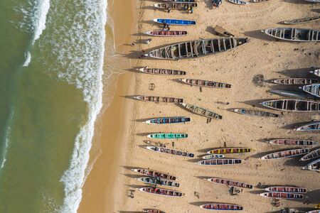 Aerial view of fishing village, pirogues fishing boats in Kayar, Senegal.  Photo made by drone from...