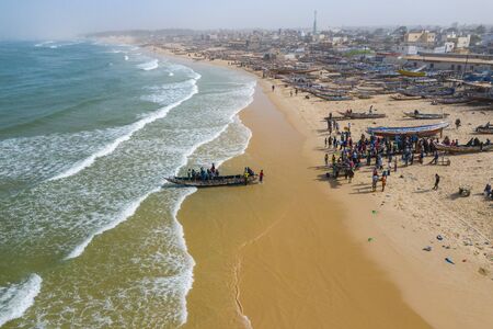 Aerial view of fishing village, pirogues fishing boats in Kayar, Senegal.  Photo made by drone from...