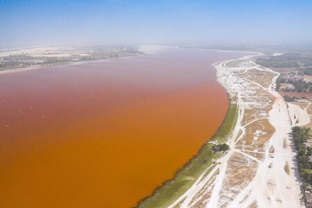 Aerial view of the Pink Lake Retba or Lac Rose in Senegal. Photo made by drone from above. Africa...