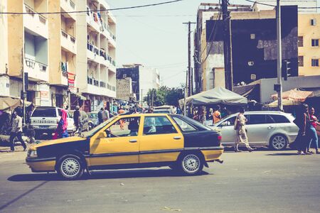 DAKAR, SENEGAL - NOVEMBER 11, 2019: People working and traffic at Senegal capital Dakar, West Africa.のeditorial素材