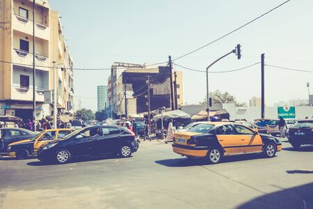 DAKAR, SENEGAL - NOVEMBER 11, 2019: People working and traffic at Senegal capital Dakar, West...