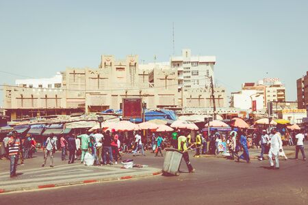 DAKAR, SENEGAL - NOVEMBER 11, 2019: People working and traffic at Senegal capital Dakar, West Africa.のeditorial素材