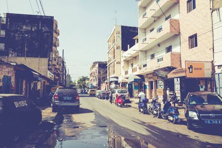 DAKAR, SENEGAL - NOVEMBER 11, 2019: People working and traffic at Senegal capital Dakar, West Africa.のeditorial素材