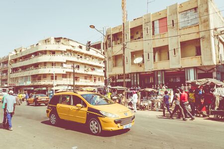 DAKAR, SENEGAL - NOVEMBER 11, 2019: People working and traffic at Senegal capital Dakar, West Africa.のeditorial素材