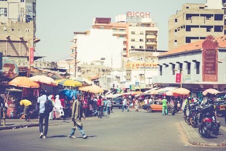 DAKAR, SENEGAL - NOVEMBER 11, 2019: People working and traffic at Senegal capital Dakar, West Africa.のeditorial素材