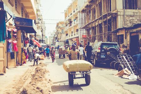 DAKAR, SENEGAL - NOVEMBER 11, 2019: People working and traffic at Senegal capital Dakar, West Africa.のeditorial素材