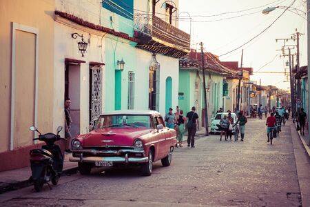 TRINIDAD, CUBA - DECEMBER 16, 2019: Colorful houses and vintage cars in Trinidad, Cuba. Unesco World...