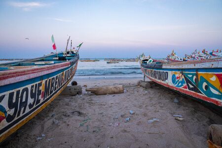 TANJI, THE GAMBIA - NOVEMBER 21, 2019: Traditional fishing boats in Tanji. Fishing village. Gambia,...