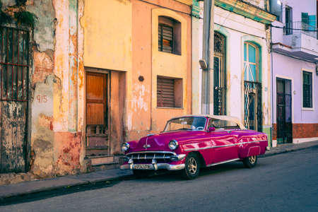 HAVANA, CUBA - DECEMBER 10, 2019: Havana Cuba Classic Cars. Typcal Havana urban scene with colorful...