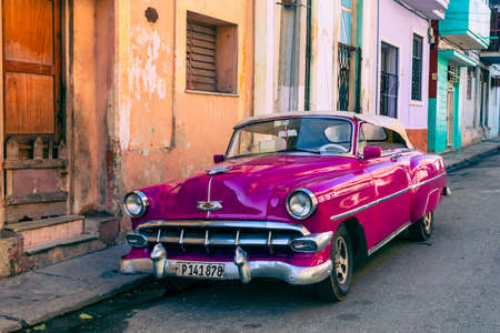 HAVANA, CUBA - DECEMBER 10, 2019: Havana Cuba Classic Cars. Typcal Havana urban scene with colorful...