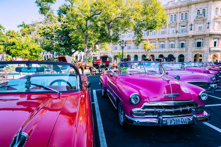 HAVANA, CUBA - DECEMBER 10, 2019: Havana Cuba Classic Cars. Typcal Havana urban scene with colorful buildings and old cars.のeditorial素材