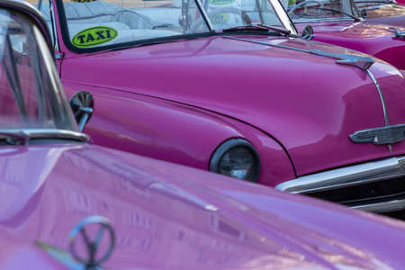 HAVANA, CUBA - DECEMBER 10, 2019: Havana Cuba Classic Cars. Typcal Havana urban scene with colorful...
