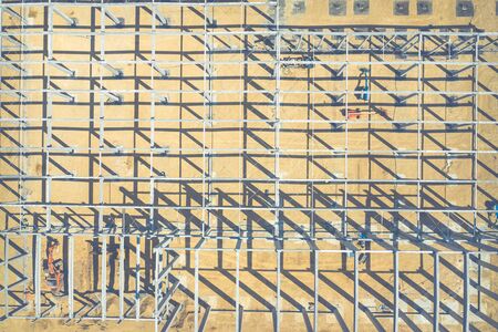 Construction site from above. Top view of factory under construction with heavy machinery. Picture made by drone from above.の写真素材