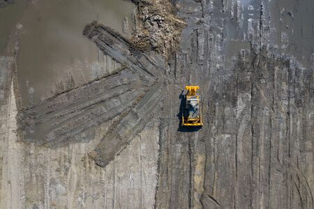 Aerial view of industrial mineral open pit mine. Opencast mining quarry with lots of machinery at...