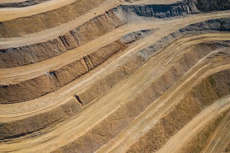 Aerial view of industrial terraces on mineral open pit mine. Opencast mining. Drone view from above.の写真素材