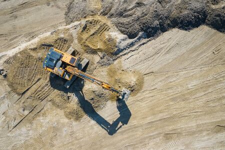 Aerial view of industrial mineral open pit mine. Opencast mining quarry with lots of machinery at...