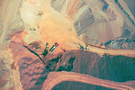 Mining from above. Industrial open pit mineral mine. Aerial view of opencast mining. Mine Excavation. Extractive industry. Giant excavator machinery.の写真素材