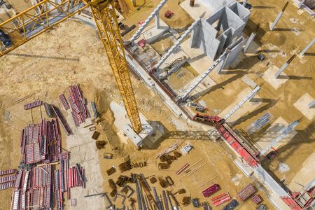 Construction site from above. Aerial view of workplaces in construction equipment, workers with...